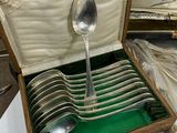 a box with a set of silver spoons in it