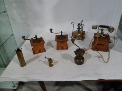 a lot of old fashioned telephones on a table