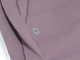 a close up of a purple jacket with a button on it