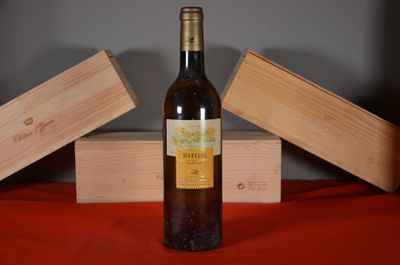 a bottle of wine sitting on a table next to two wooden boxes