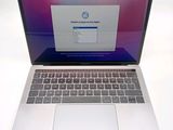 a laptop computer that is open on a white surface