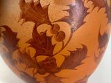 a vase with a plant in it sitting on a table