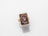 a gold ring with an image of a woman in profile