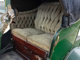 an old car with a couch in the back of it