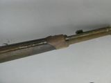 a very old gun that is laying on a table