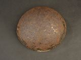 an old rusted iron ball sitting on top of a black surface