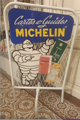 a sign that says michel on it in front of a window