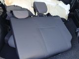 a seat in the back of a car with a table in it