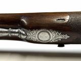 a close up of a rifle with a wooden handle