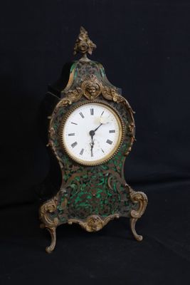 a small clock that is sitting on a black surface