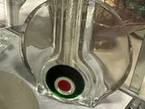a glass vase with a green and red design on it