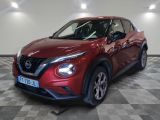 the red nissan juke suv is parked in the garage