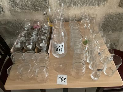bottles and glasses on a table with price tags on them