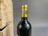 a bottle of wine sitting next to a wooden box