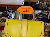 a yellow handbag with a price tag on it