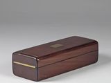 a small wooden box with a brass plate on top of it