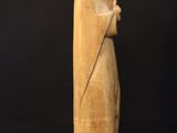 a statue of a woman standing on top of a rock