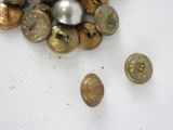 a lot of buttons that are laying on a table