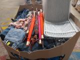 a cardboard box filled with umbrellas and other items