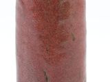 a red vase that is sitting on a white surface