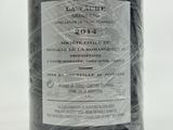 a bottle of wine wrapped in plastic on a table