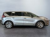 the silver car is parked in a large room with a gray floor