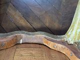 a piece of wood sitting on the floor next to a chair