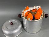 carrots in a metal container with a lid and a spoon