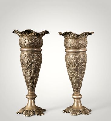 a pair of antique brass vases on a white background