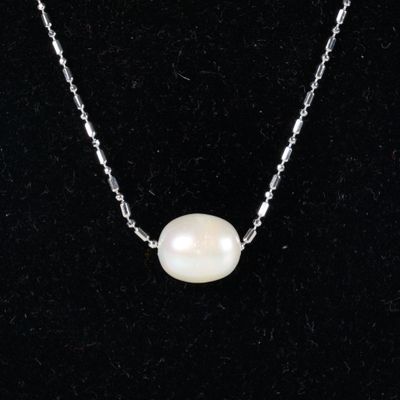 a white pearl necklace on a silver chain