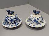 three blue and white dishes on a white table