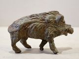 a small bronze statue of a boar on a table