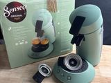 a box with a coffee maker next to it on a table
