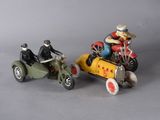 two figurines of people riding motorcycles and a car
