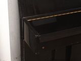 a black piano sitting next to a stool in a room