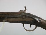 a close up of a gun with a white ribbon on it