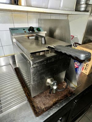 stainless steel counter top in a commercial kitchen with pots and pans on it