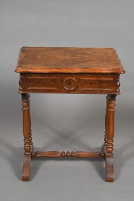 an old wooden table with a drawer on top of it