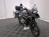 a motorcycle that is parked in a room with a checkered floor