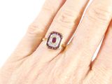 an image of a woman ' s hand with a diamond and ruby ring