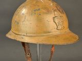 an old fireman ' s helmet on a stand against a gray background
