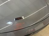 someone is cleaning the hood of a car with a brush