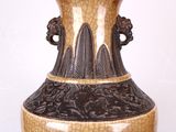 a vase with a brown and black design on it