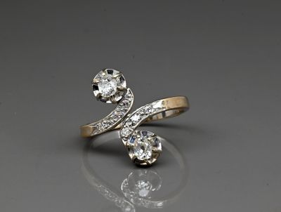 a close up of a diamond ring on a reflective surface
