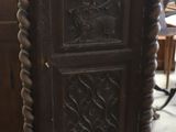 a tall wooden cabinet in the middle of a room
