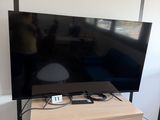 a flat screen tv sitting on top of a wooden cabinet