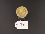 a close up of a gold coin on a black surface