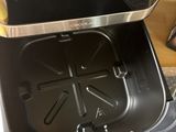 a person that is opening the lid of a trash can