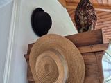 a hat on top of a wooden shelf next to a window