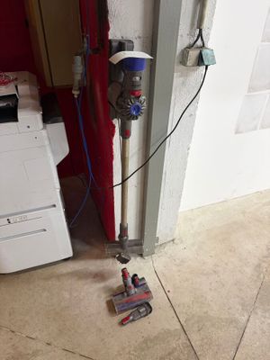 a picture of a vacuum and a dryer in a room